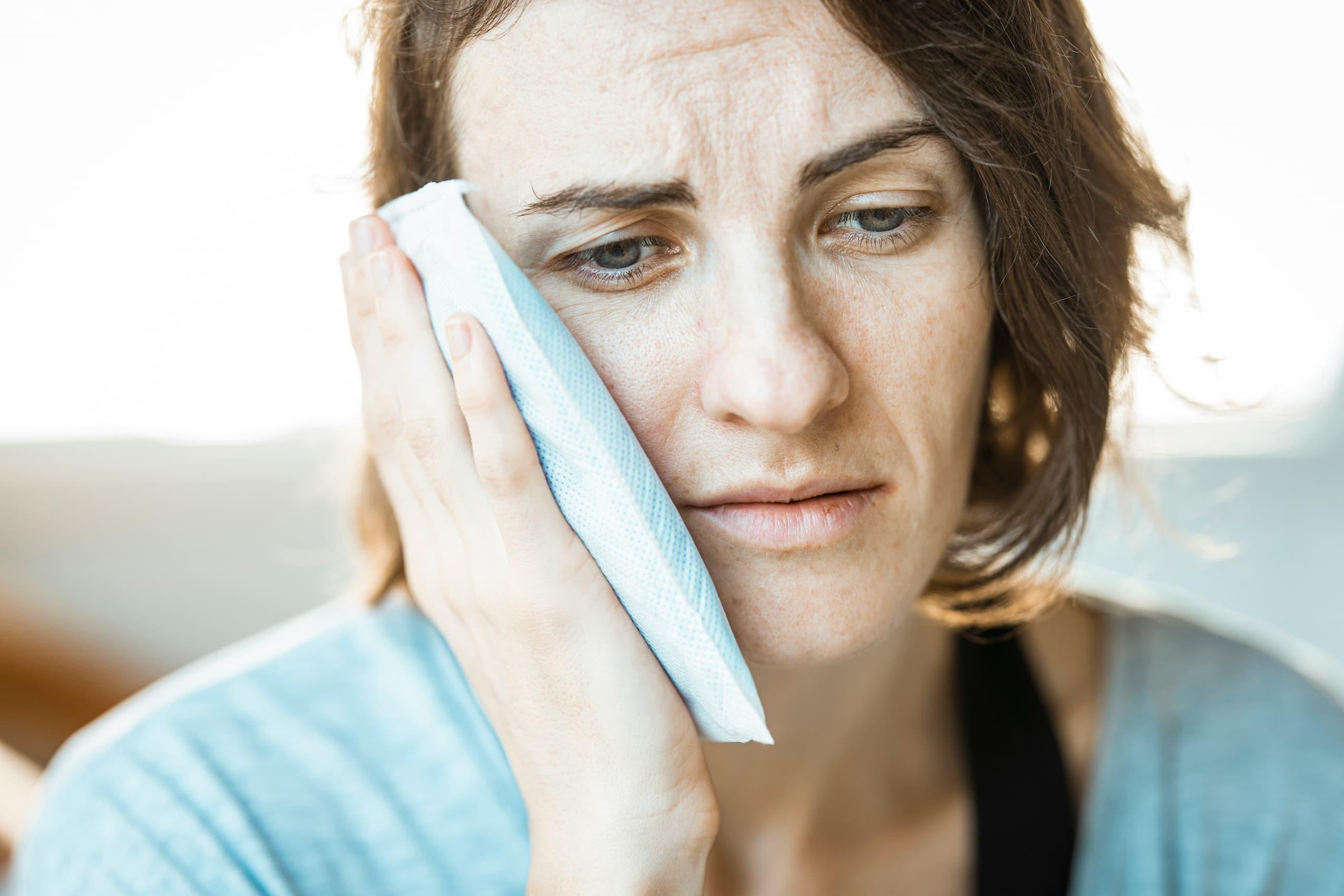 Person experiencing jaw tension and headache