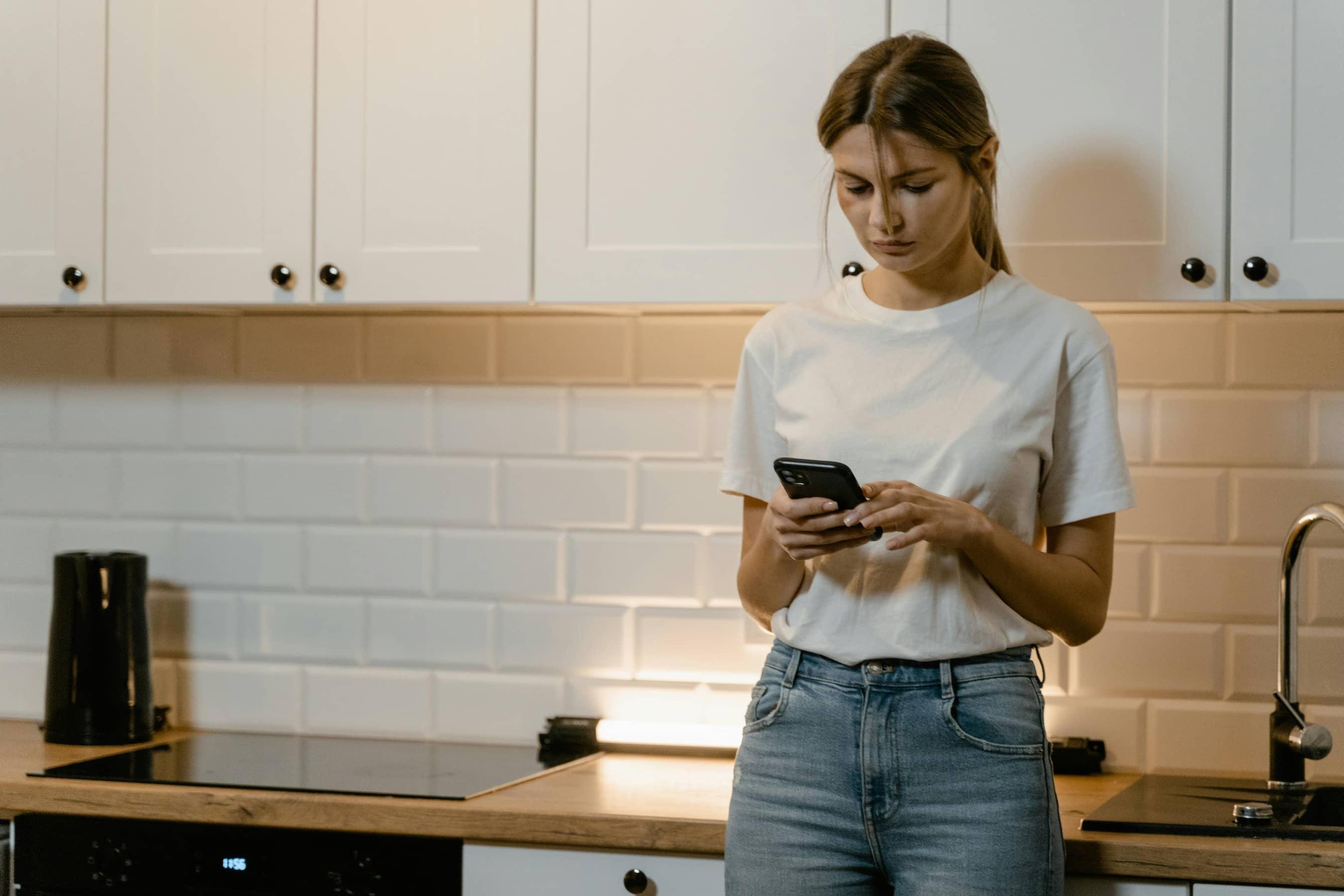 Person looking stressed while looking at their phone
