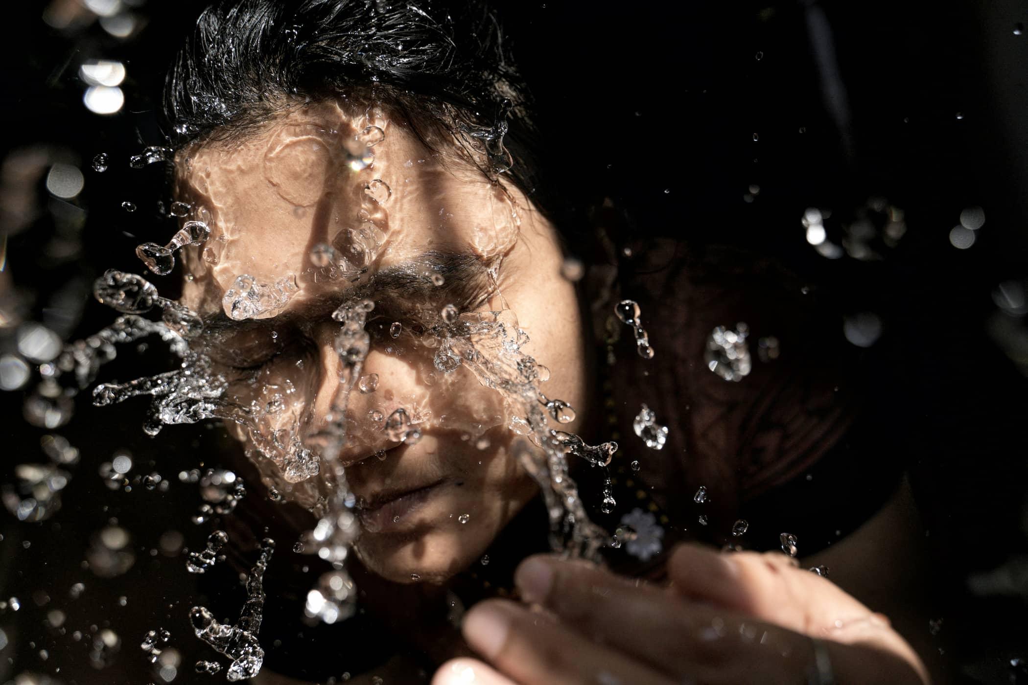 A person splashing extremely cold water onto their face